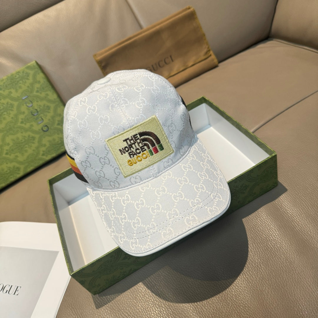 White Gucci baseball cap with GG monogram and The North Face logo patch