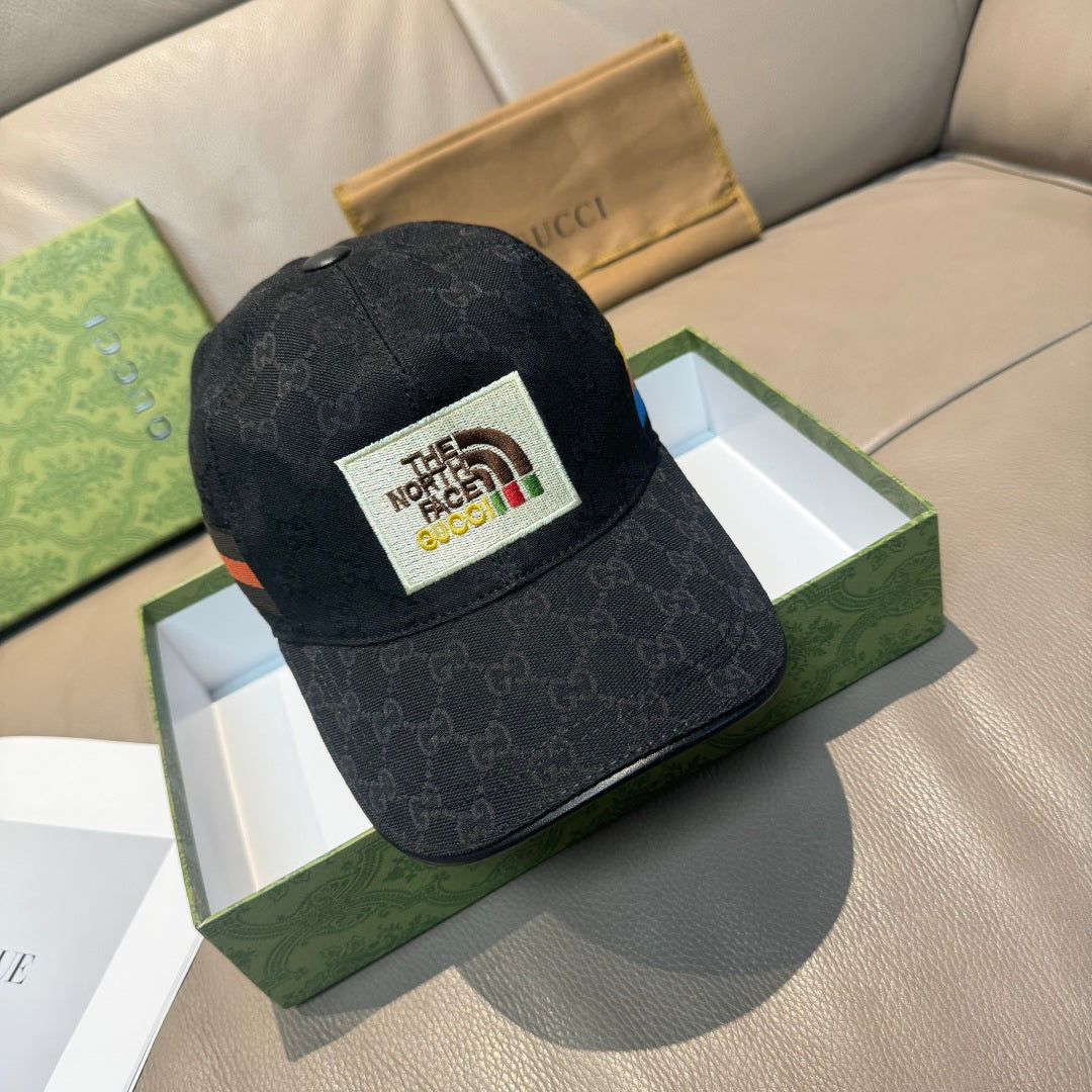 Black Gucci cap with black patterned fabric and white The North Face logo patch
