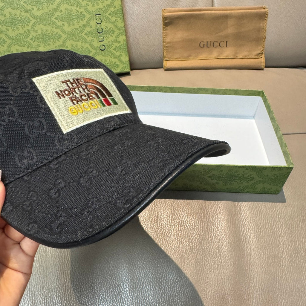 Black Gucci cap with textured monogram pattern and curved brim