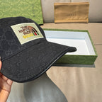 Black Gucci cap with textured monogram pattern and curved brim