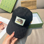 Black Gucci cap with white The North Face logo patch and multicolor stripe