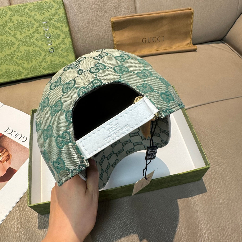 Gucci teal GG monogram cap interior view with white label and adjustable strap.
