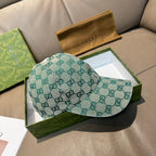Gucci GG monogram baseball cap, teal fabric, curved brim, side profile.