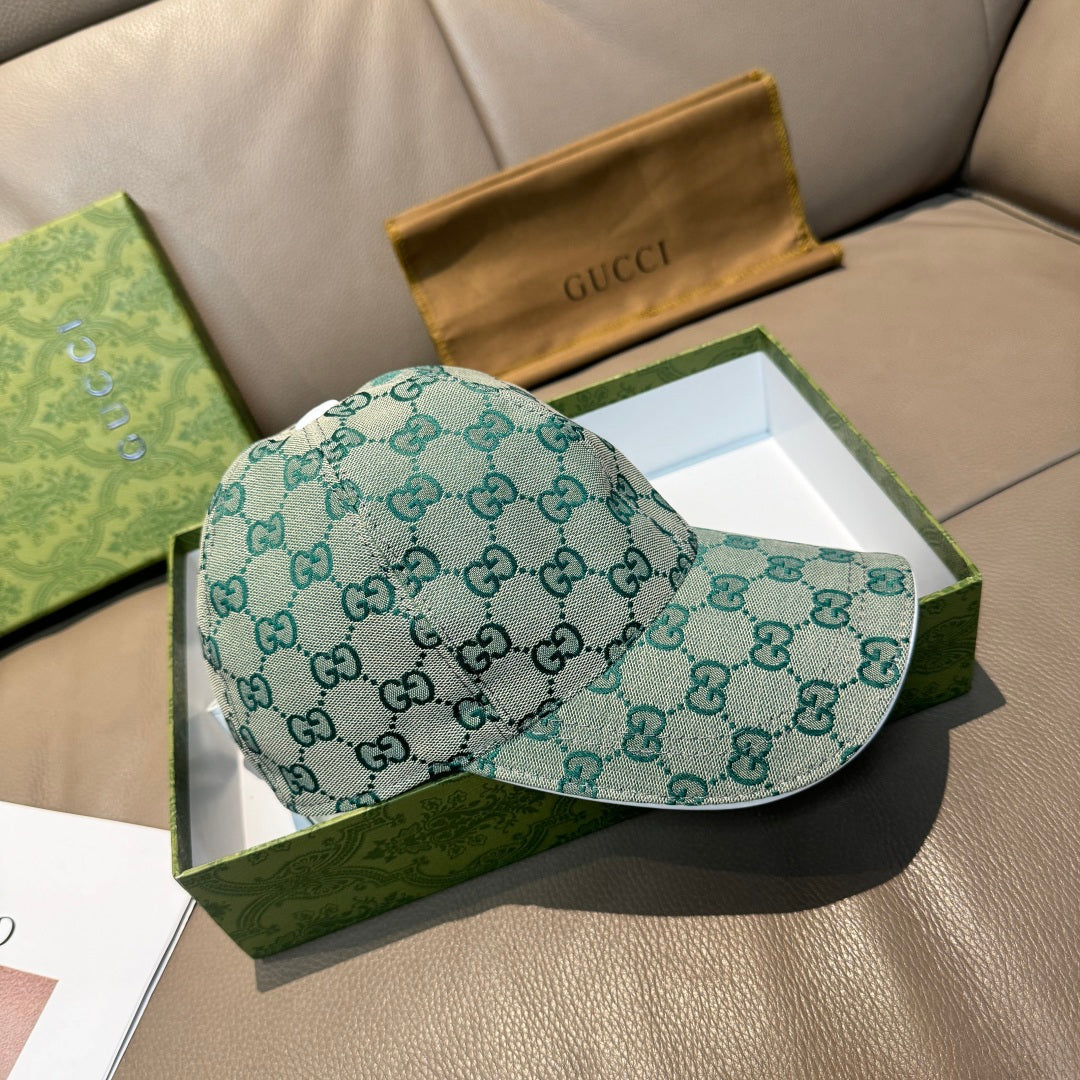 Gucci GG monogram baseball cap, teal fabric, curved brim, side profile.