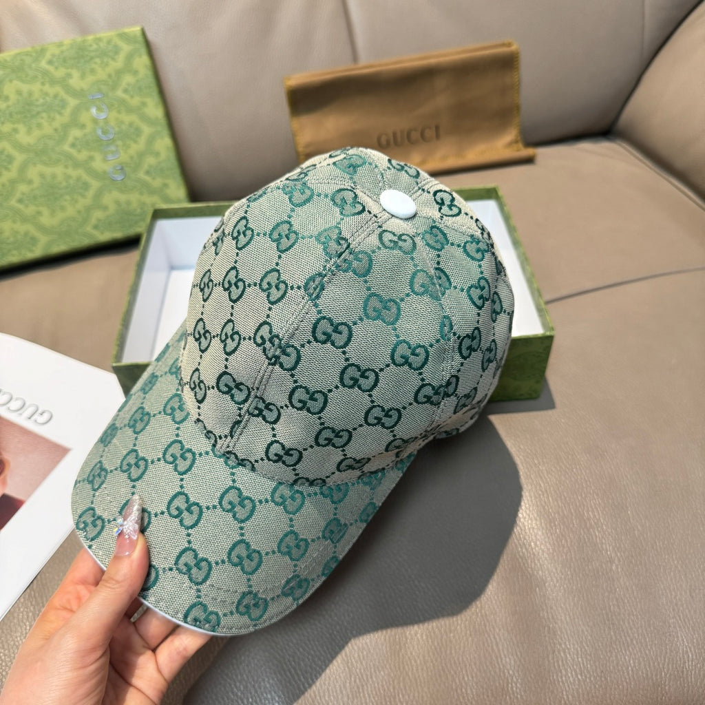 Teal Gucci GG monogram baseball cap with white snap button, curved brim.