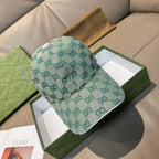 Gucci cap in teal GG monogram canvas, curved brim, adjustable strap at back.