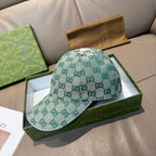 Gucci cap in teal GG monogram canvas with curved brim and top button detail.