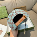 Gucci cap interior detail with light blue GG monogram and tan leather strap