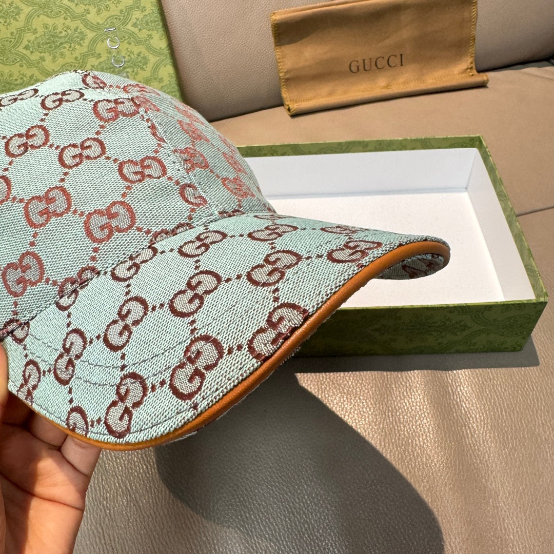 Gucci cap side view in light blue GG monogram canvas with brown underside brim