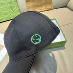 Black baseball cap with green GG logo patch on back side