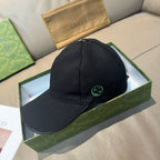 Black Gucci baseball cap with green GG logo patch on front