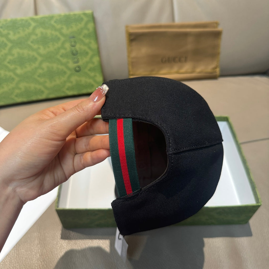 Black baseball cap with multicolor green and red stripe trim