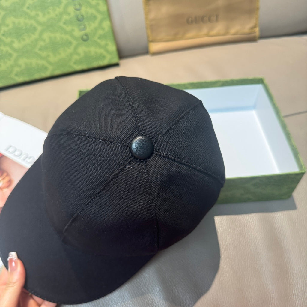 Black baseball cap with round crown button and stitched panels
