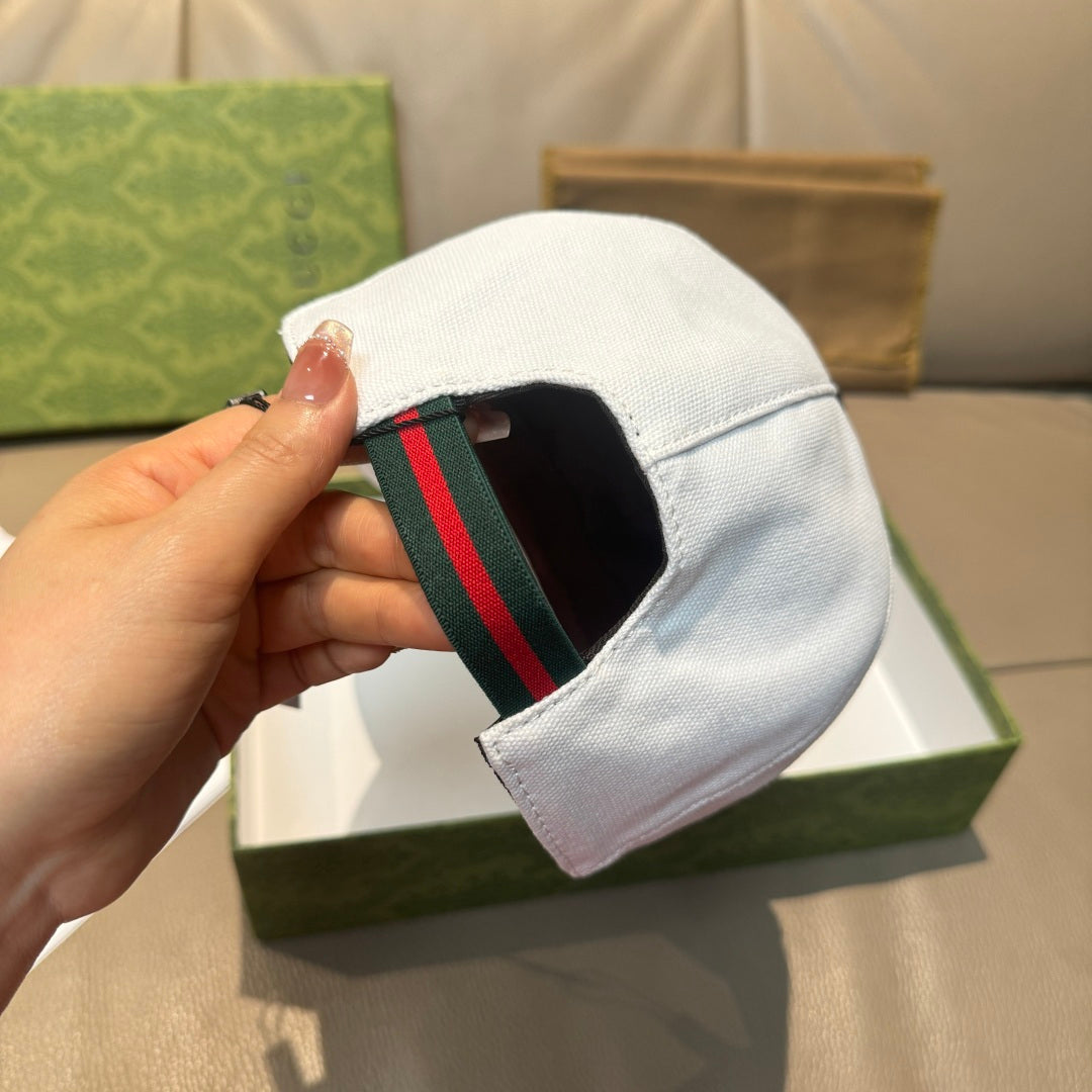 Gucci white cap with green and red Web stripe on side.
