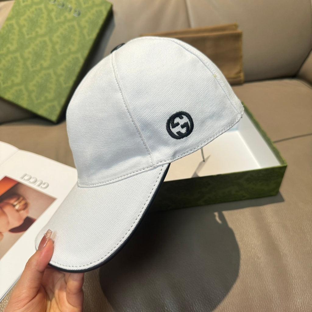 Gucci white cap with circular GG logo on front panel.