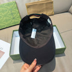 Black baseball cap interior view with adjustable strap and label