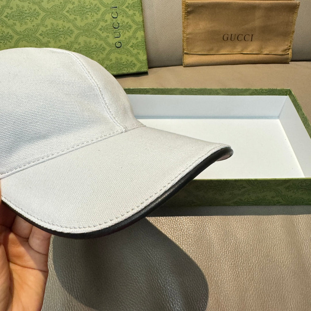Gucci white cap with black underside brim edge.