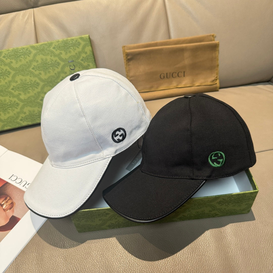 White and black Gucci baseball caps with GG logos, side-by-side