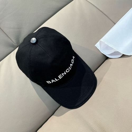 Balenciaga black baseball cap with faux pearl top button and front logo