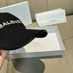 Black baseball cap brim close-up with BALENCIAGA logo panel