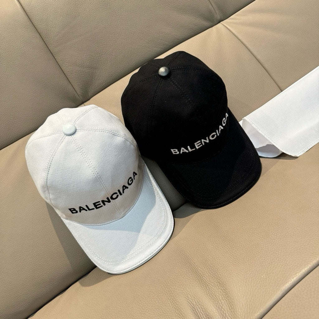 White and black baseball caps with BALENCIAGA logos
