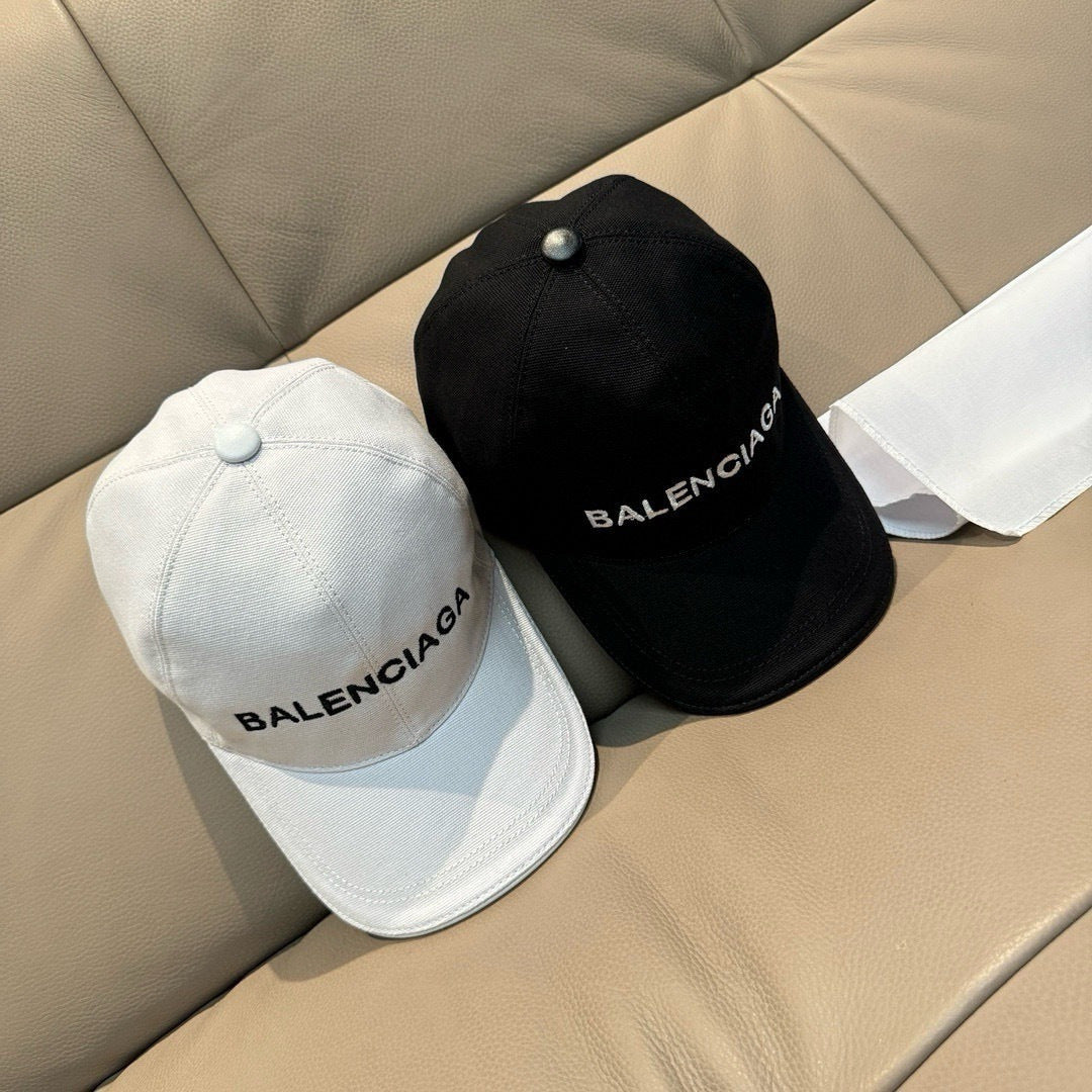 White and black baseball caps with BALENCIAGA logos