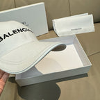 White baseball cap brim close-up with BALENCIAGA lettering