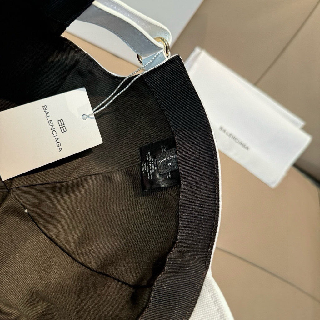 Black Balenciaga baseball cap with embroidered logo and curved brim.