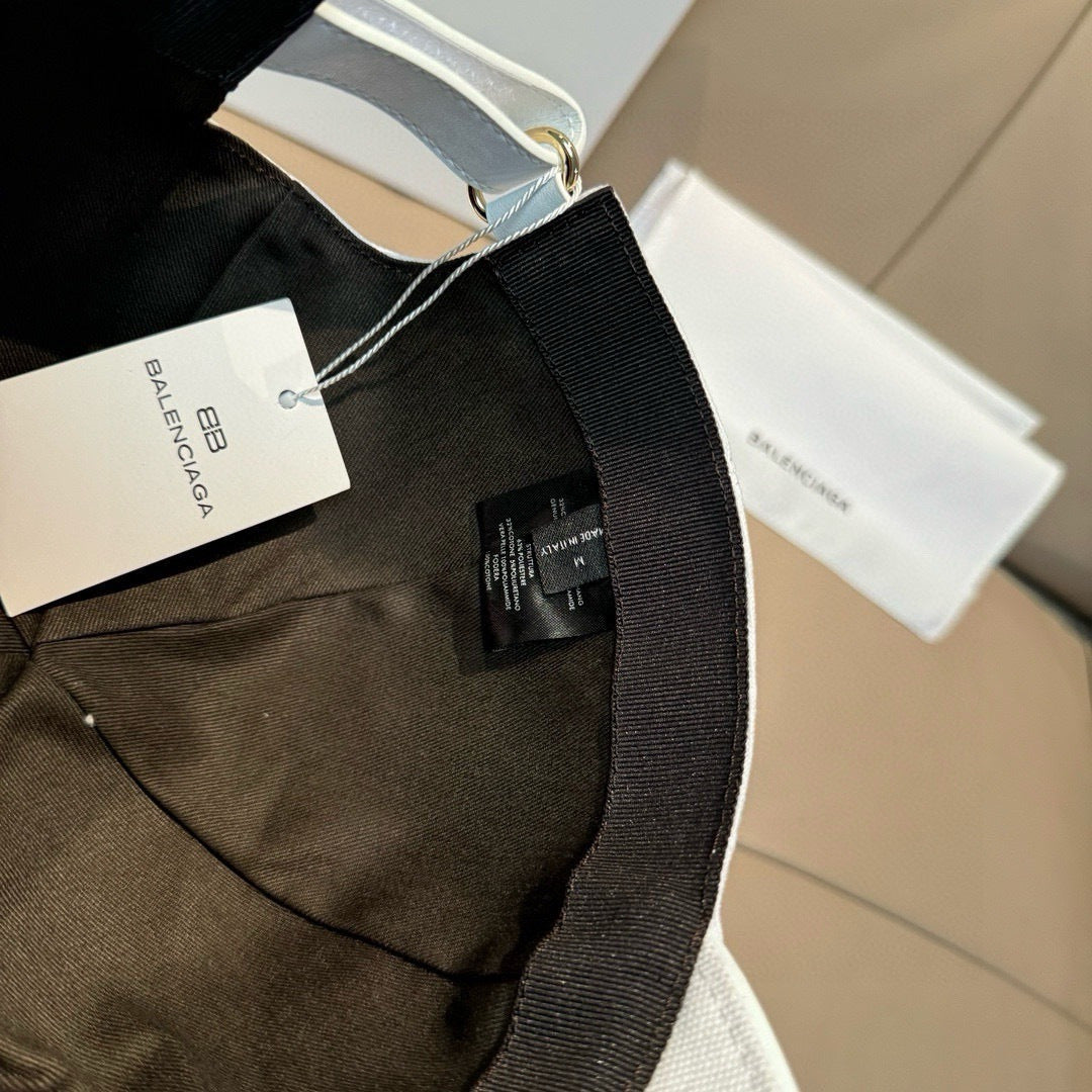 Black cap with hanging tag and adjustable strap detail