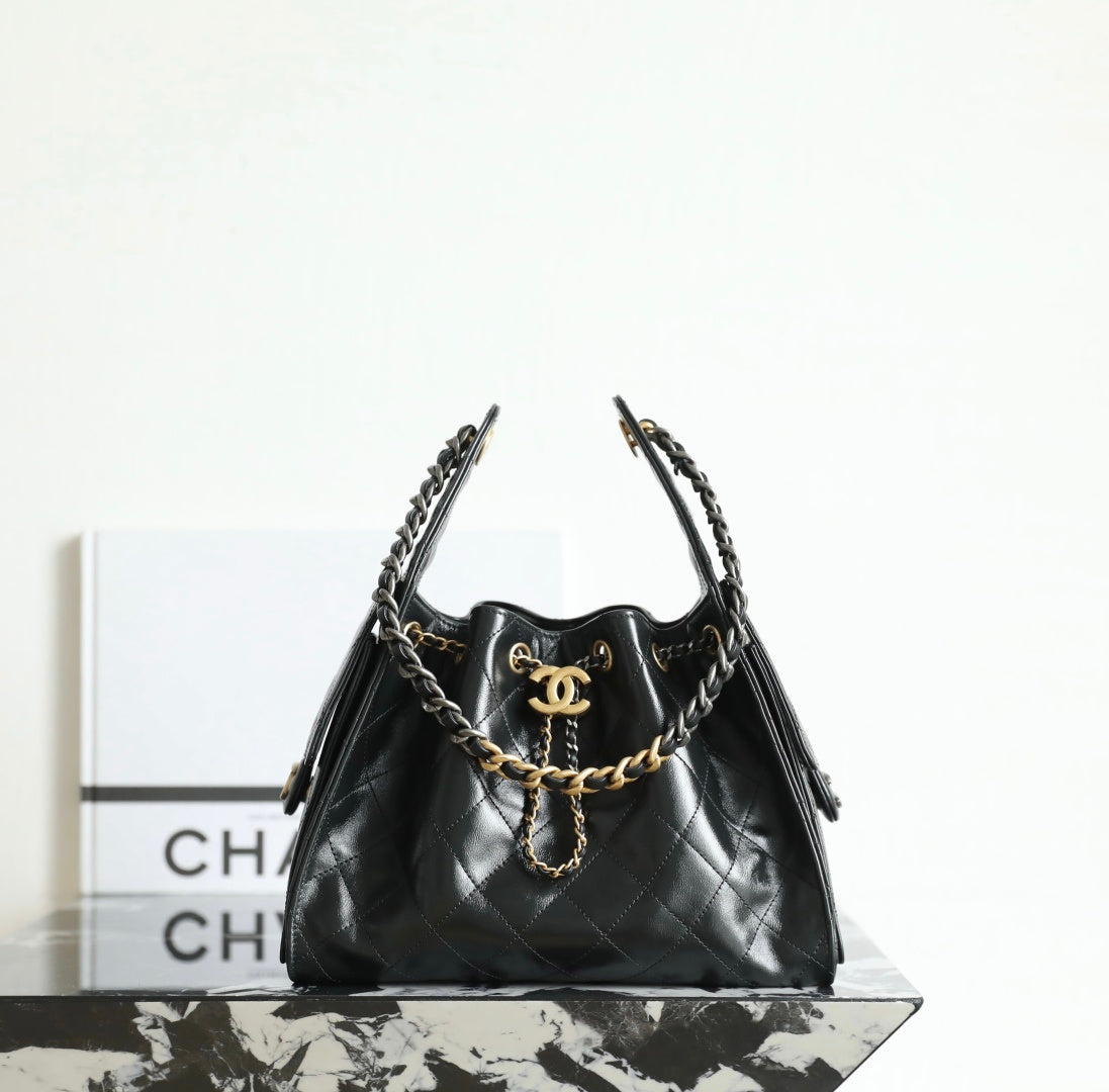Chanel quilted leather hobo bag in dark tone with gold chain strap and logo charm