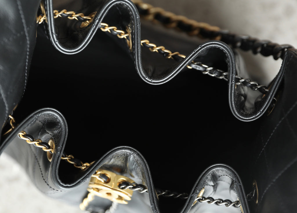Chanel bag interior with dark lining and gold-tone chain hardware and trim edges