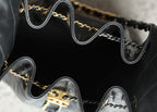 Chanel bag interior with dark lining and gold-tone chain hardware and trim edges