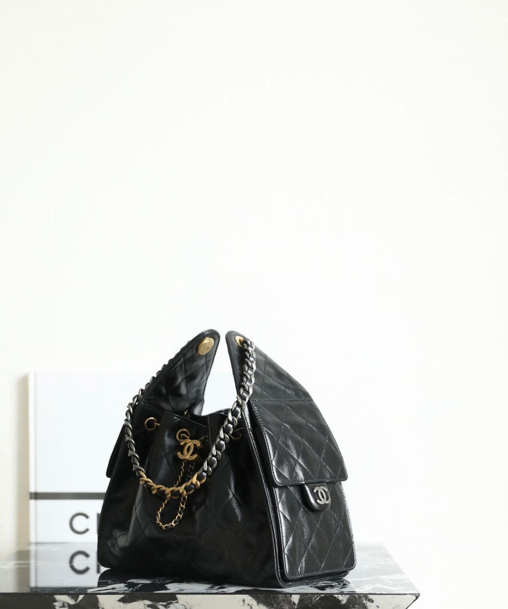 Chanel quilted leather bag with gold chain shoulder strap and small front flap