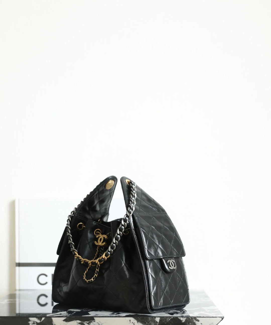 Chanel quilted leather bag with gold chain shoulder strap and small front flap