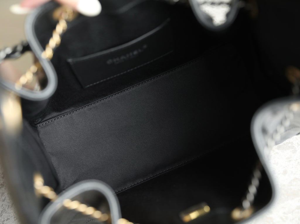 Chanel bag interior with dark lining, small pocket, and part of chain strap