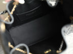 Chanel bag interior with dark lining, small pocket, and part of chain strap