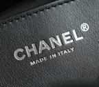 Chanel leather label with embossed “MADE IN ITALY” text on dark finish
