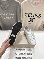 Golden Goose luxury sneakers: white outsole with textured tread, held above the display