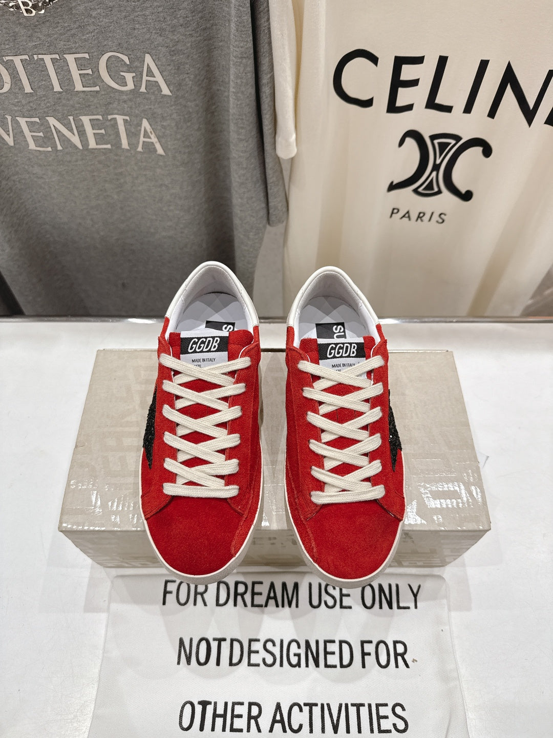 Golden Goose red sneakers with white laces and white rubber sole, pair front view