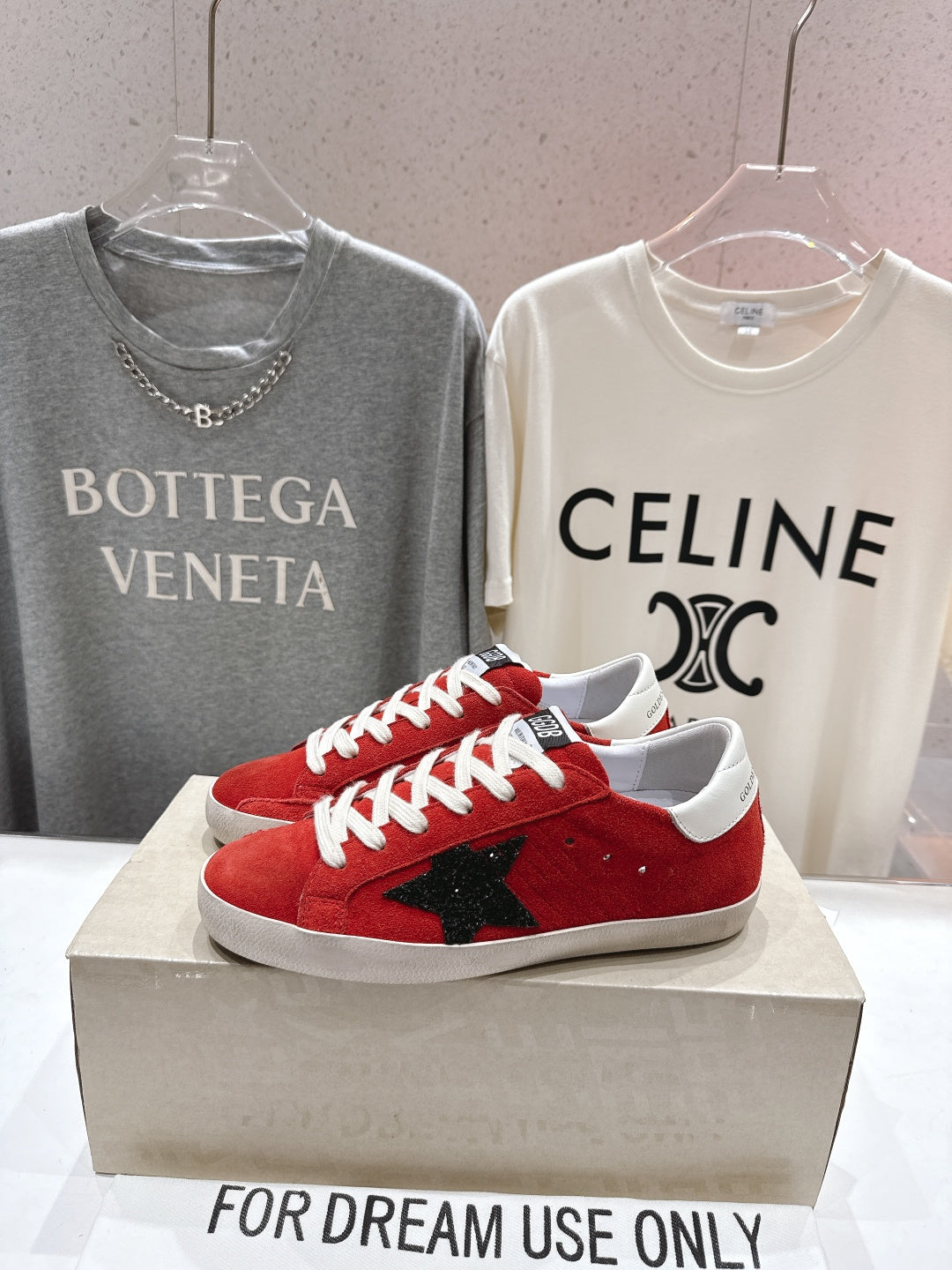 Golden Goose red sneakers with black star patch, white laces and white sole, side view