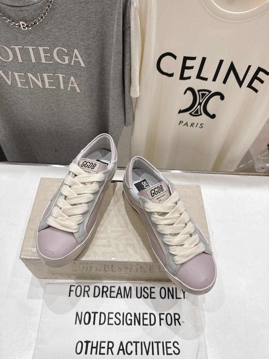 Lilac and white lace-up sneakers with star detail, angled side view pair