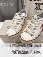 White lace-up sneakers with side panels, printed tongue labels, and tan gum soles