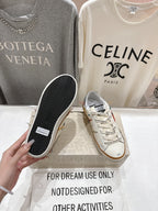 White sneaker with black textured outsole shown, plus matching tan gum sole pair