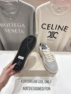 Sneaker outsole with black rubber tread, paired with light gray-and-white upper