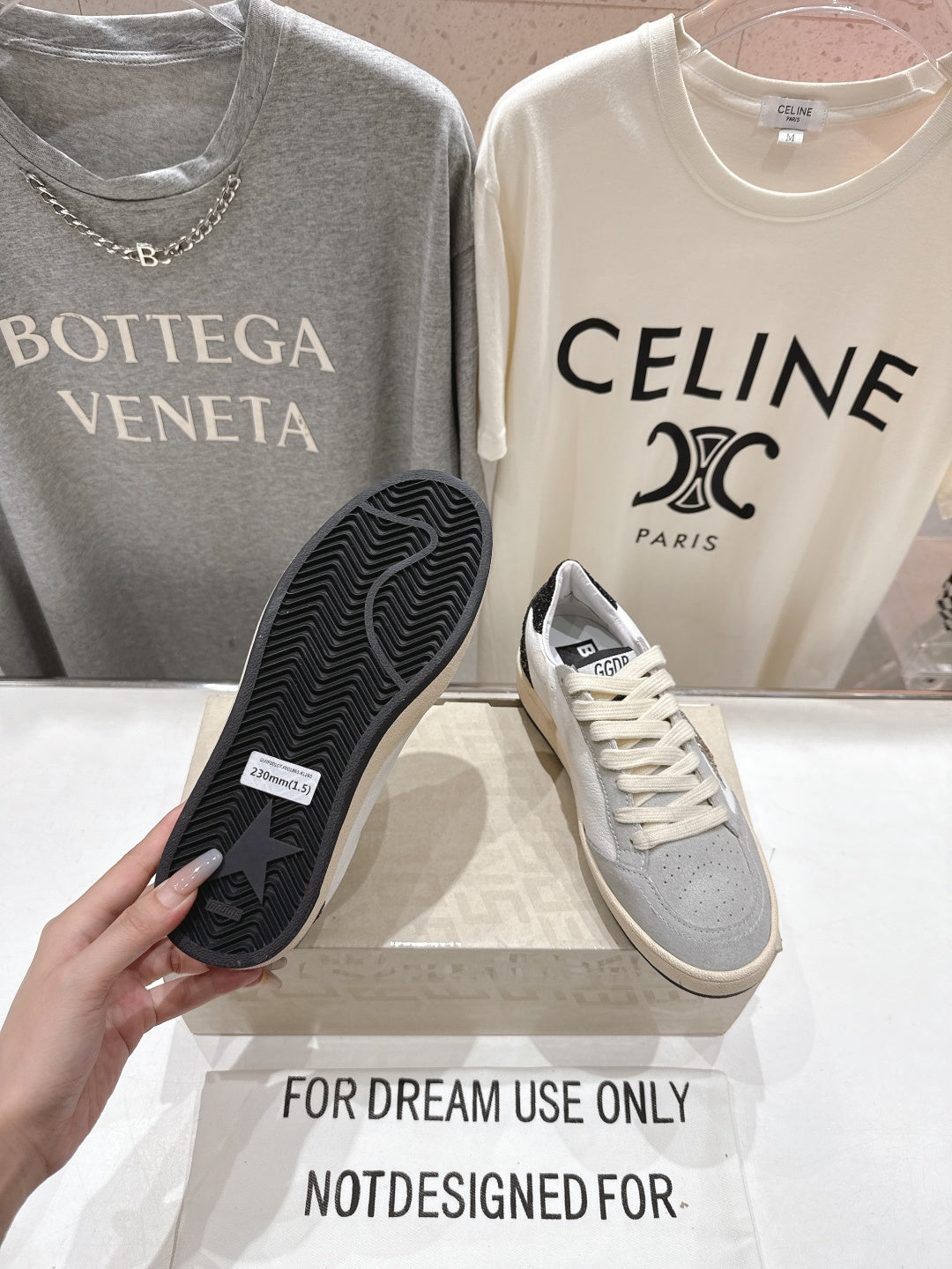 Sneaker outsole with black rubber tread, paired with light gray-and-white upper