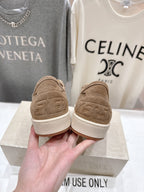 Tan low-top sneakers showing back heel and white rubber sole