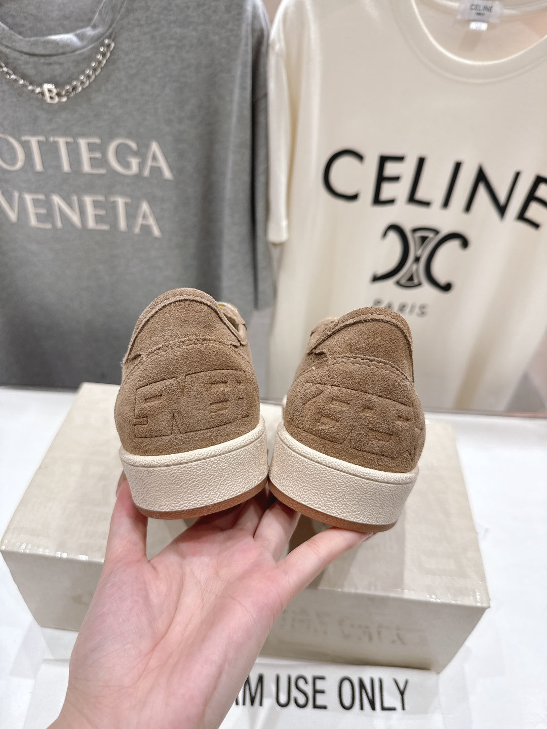 Tan low-top sneakers showing back heel and white rubber sole