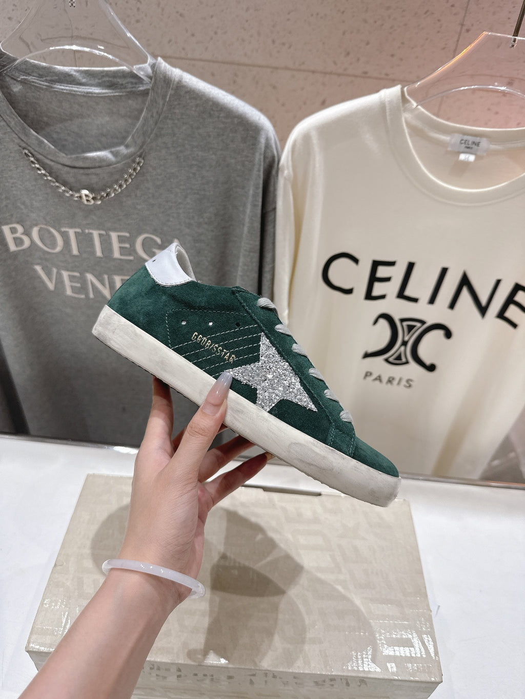 Dark green suede Golden Goose sneaker with white laces and textured side panel detail