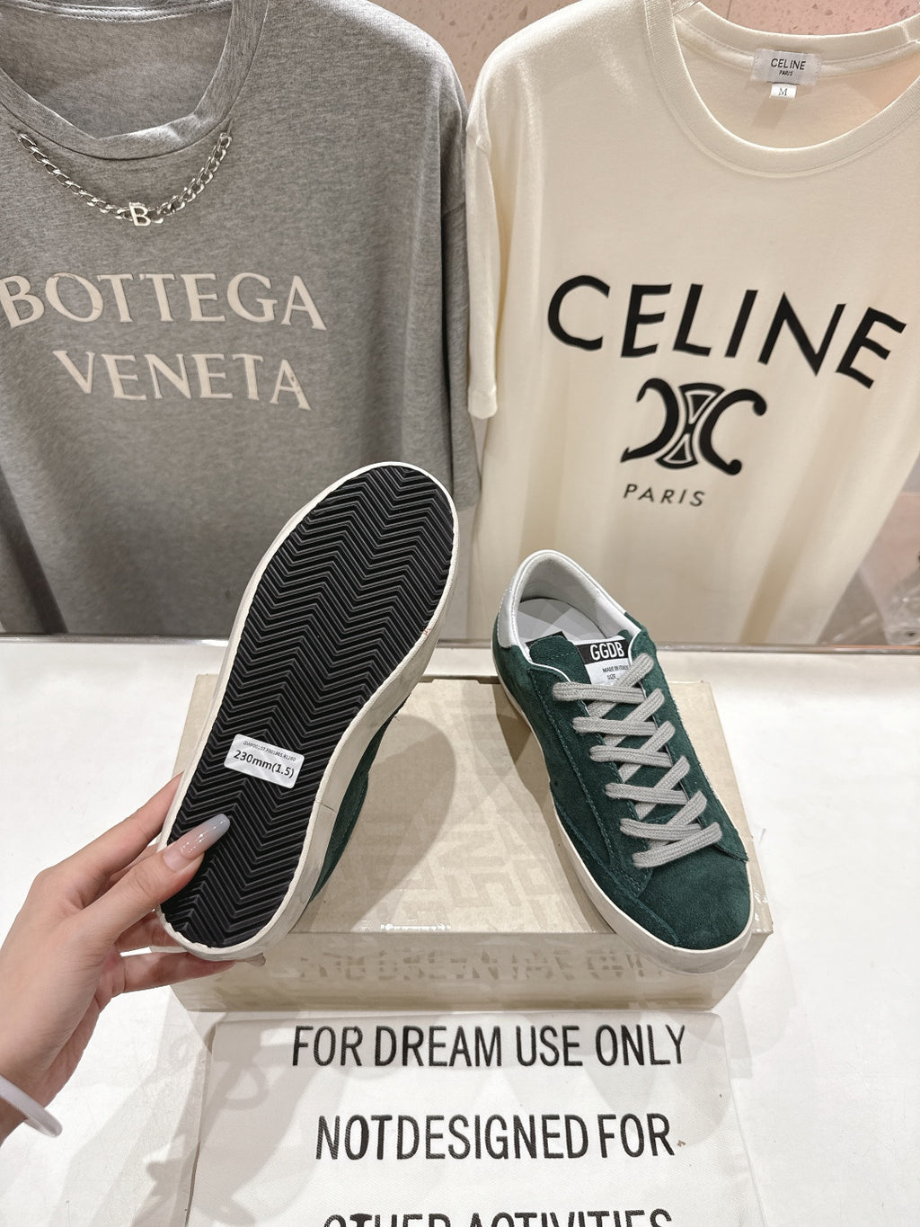 Golden Goose sneaker showing dark green suede upper and black treaded outsole