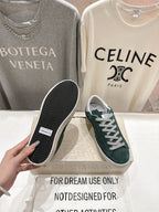 Golden Goose sneaker showing dark green suede upper and black treaded outsole